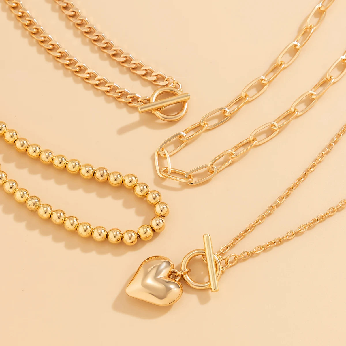 Golden Heart Elegance – A 4-Piece Y2K Necklace Set for Bold and Modern Women