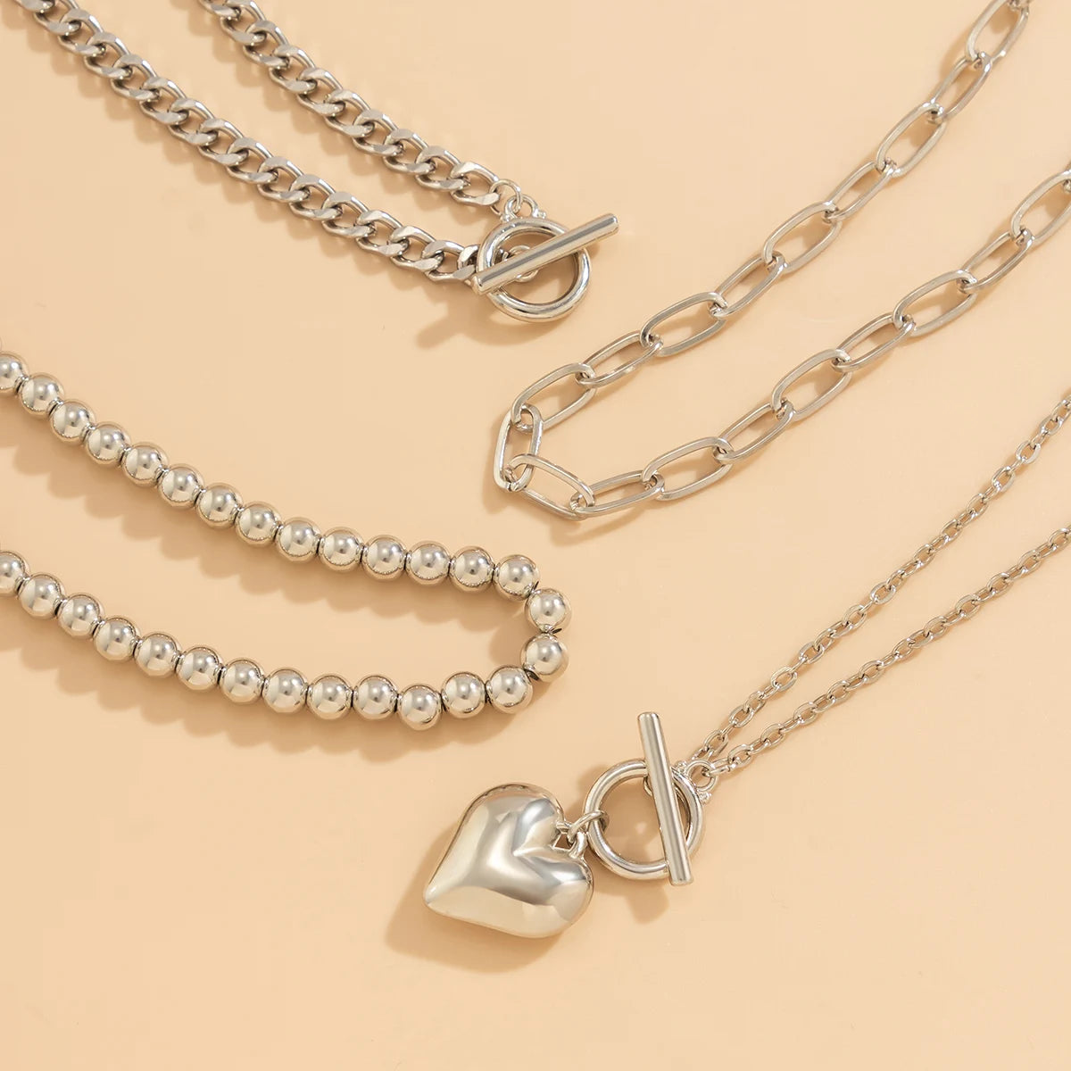 Golden Heart Elegance – A 4-Piece Y2K Necklace Set for Bold and Modern Women